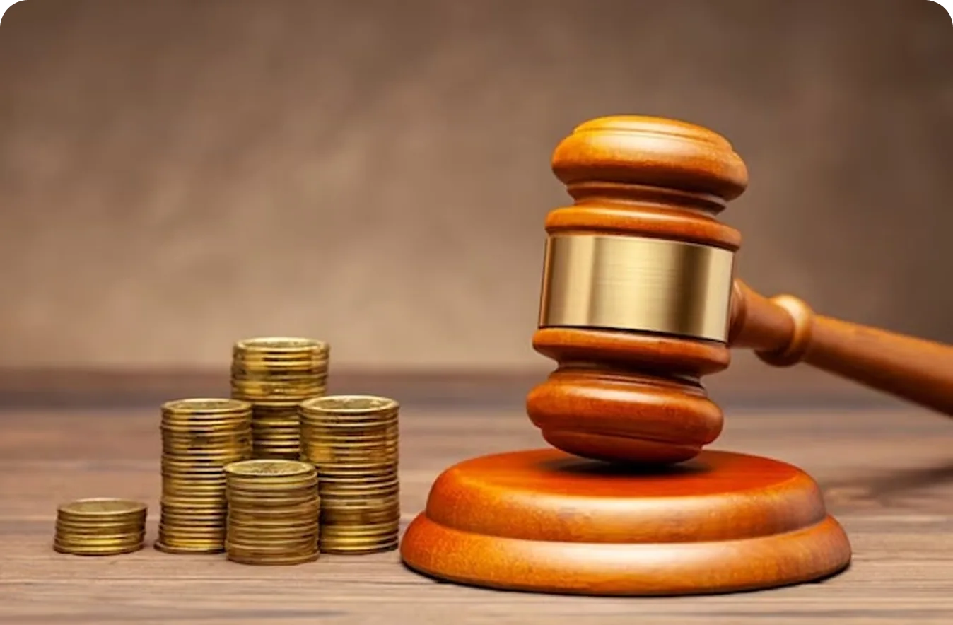 A judge's gavel beside stacked coins