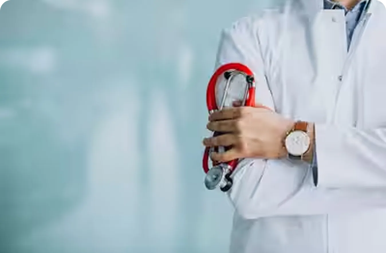 A clinician in a white coat holding a stethoscope over a heart symbol